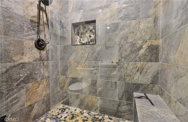 bathroom with tiled shower