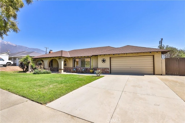 ranch-style house featuring stucco siding, concrete driveway, fence, a garage, and a front lawn