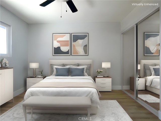 bedroom featuring ceiling fan, baseboards, and wood finished floors