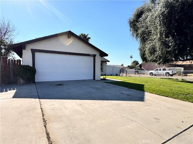 garage with driveway and fence