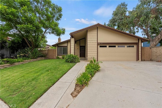 mid-century modern home with concrete driveway, a front lawn, an attached garage, and fence