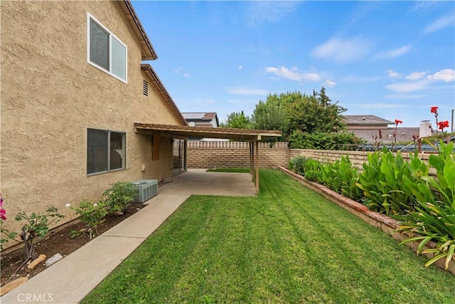 view of yard featuring a patio, cooling unit, and fence