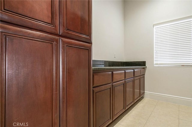 kitchen with light tile patterned floors and baseboards