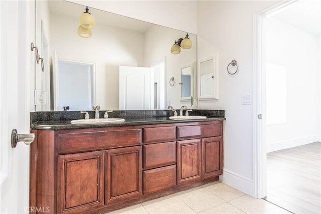 bathroom with double vanity, a sink, and tile patterned floors