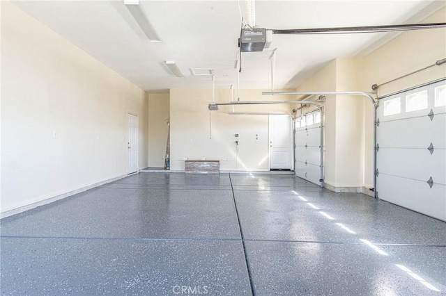 garage featuring baseboards and a garage door opener