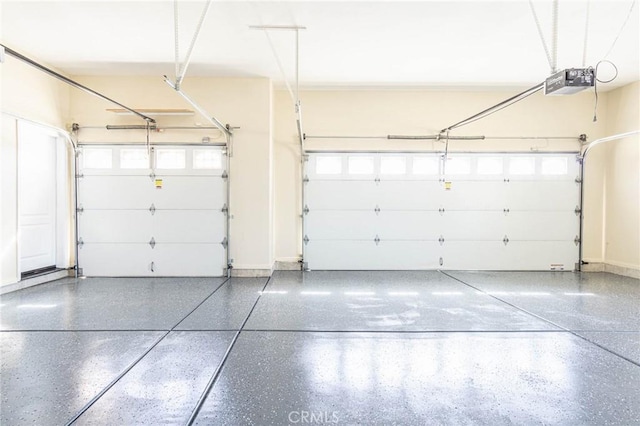 garage with baseboards and a garage door opener