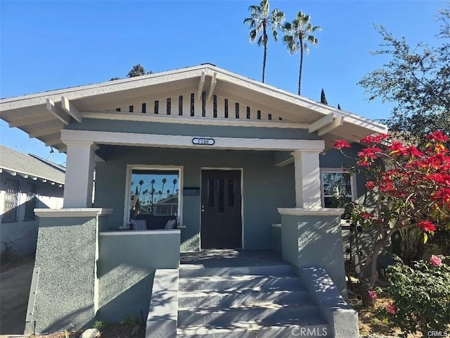 view of front of home with covered porch and stucco siding