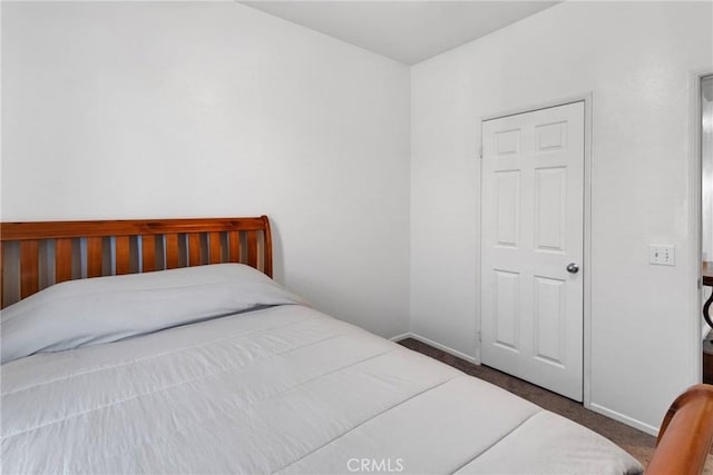 bedroom featuring carpet and baseboards