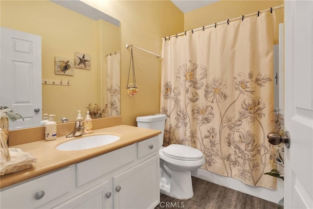 full bath with vanity, shower / bath combo, wood finished floors, and toilet