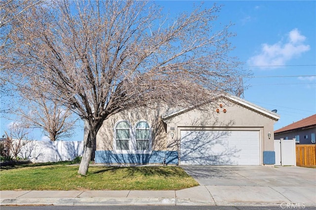 view of front of house with a garage, fence, driveway, stucco siding, and a front lawn