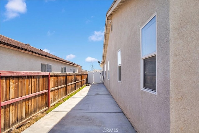 view of property exterior featuring fence and stucco siding