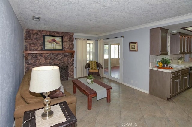 living room featuring light tile patterned floors, baseboards, visible vents, ornamental molding, and a textured ceiling