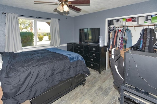 bedroom with a closet, ceiling fan, and wood finished floors