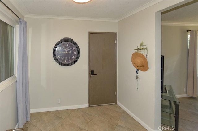 empty room featuring baseboards, ornamental molding, and tile patterned floors