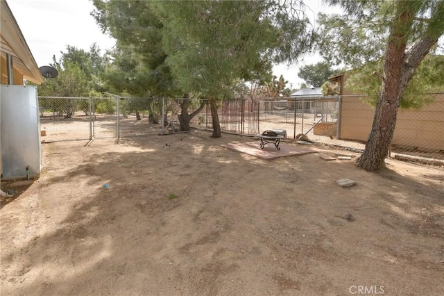 view of yard with fence and a gate