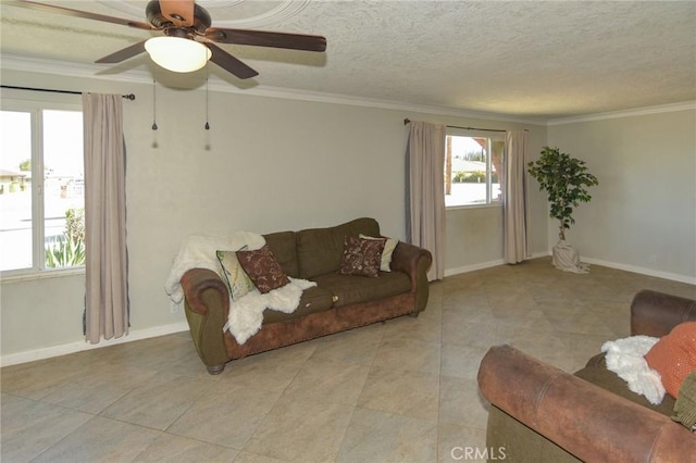 living room featuring a textured ceiling, ornamental molding, and baseboards