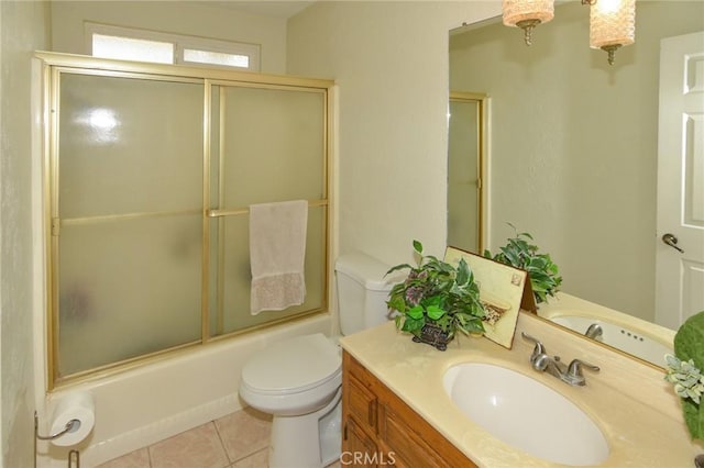 full bathroom featuring toilet, shower / bath combination with glass door, vanity, and tile patterned floors