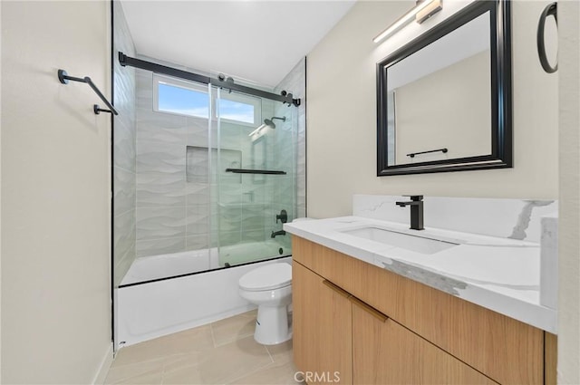 full bath featuring toilet, tile patterned floors, combined bath / shower with glass door, and vanity