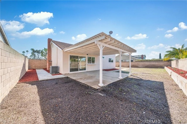 back of property with a fenced backyard, a patio, central AC, and stucco siding