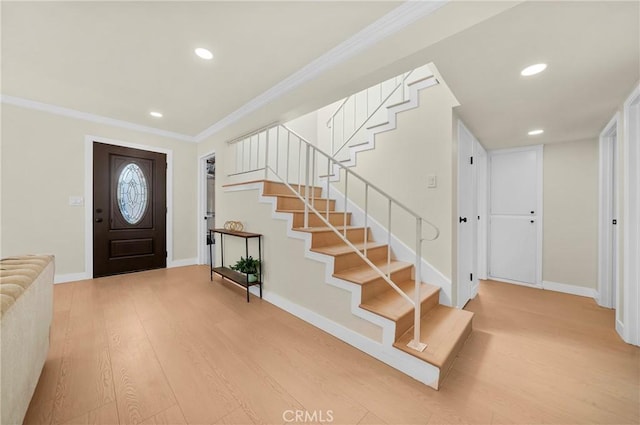 entrance foyer featuring recessed lighting, stairway, ornamental molding, wood finished floors, and baseboards