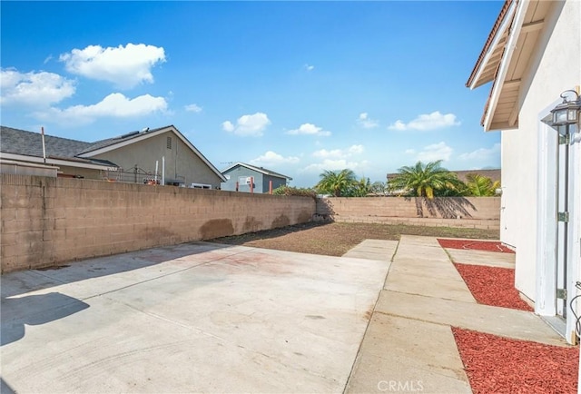 view of yard featuring a patio area and a fenced backyard