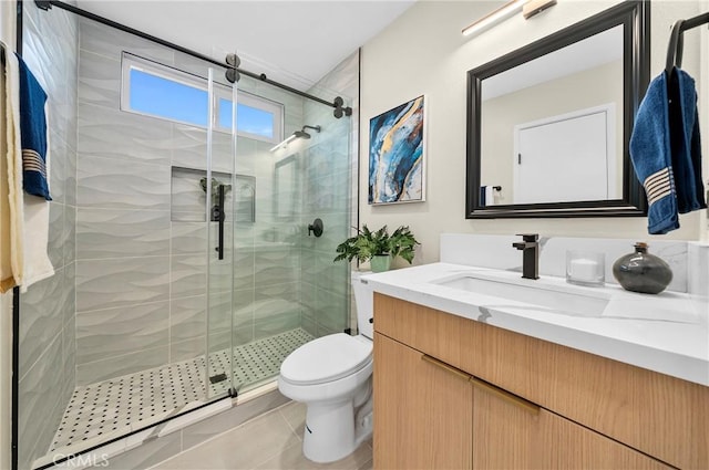 bathroom with toilet, a shower stall, vanity, and tile patterned floors