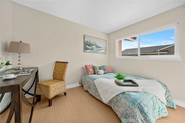 bedroom featuring baseboards and wood finished floors