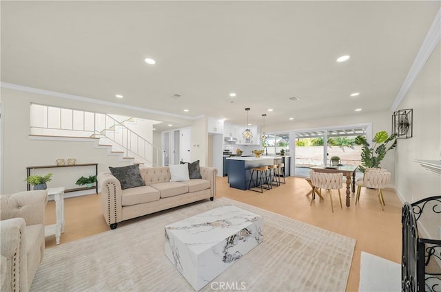 living area featuring recessed lighting, baseboards, ornamental molding, stairway, and light wood-type flooring