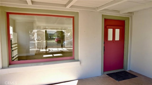 view of exterior entry featuring stucco siding