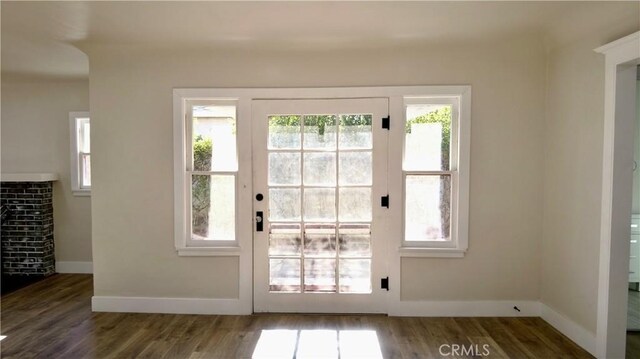 entryway with baseboards and wood finished floors
