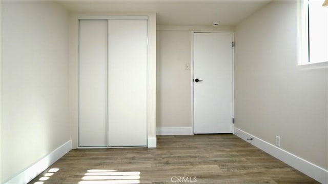 3688 Hoover St, Riverside, CA 92504 - unfurnished bedroom featuring wood finished floors, a closet, and baseboards