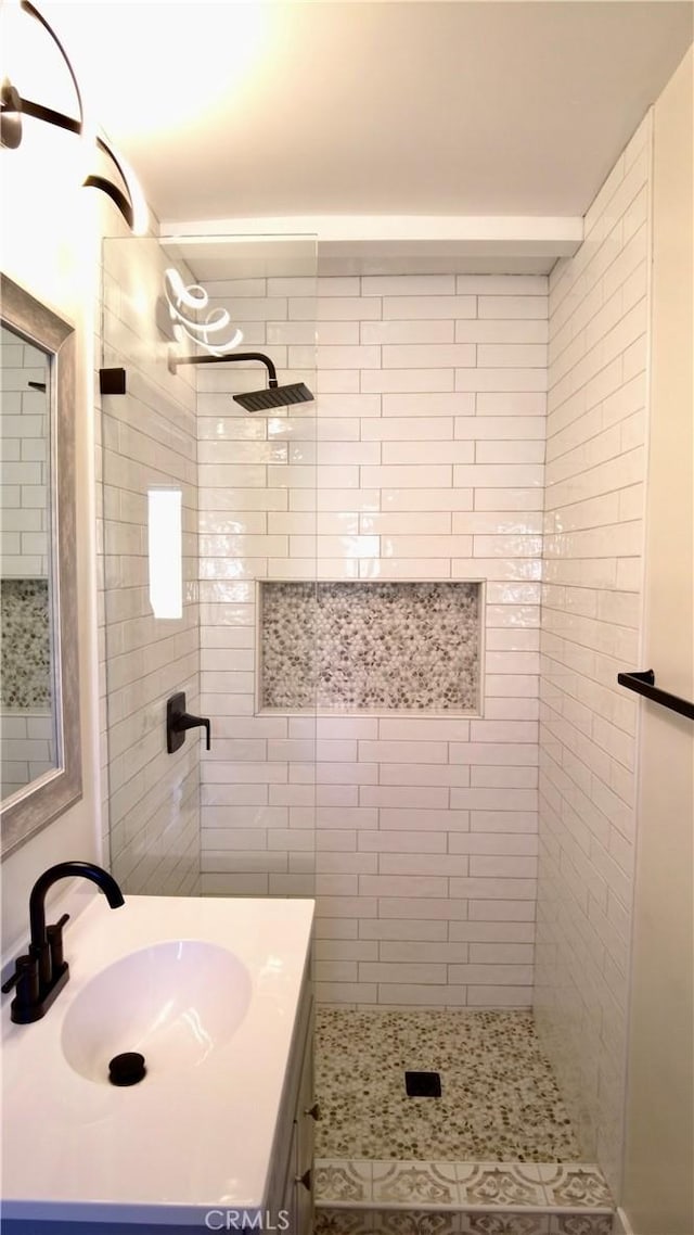 full bath with a shower stall and vanity