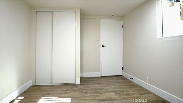 3688 Hoover St, Riverside, CA 92504 - unfurnished bedroom featuring wood finished floors, a closet, and baseboards