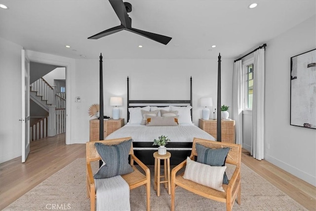 bedroom featuring ceiling fan, baseboards, light wood-style flooring, and recessed lighting