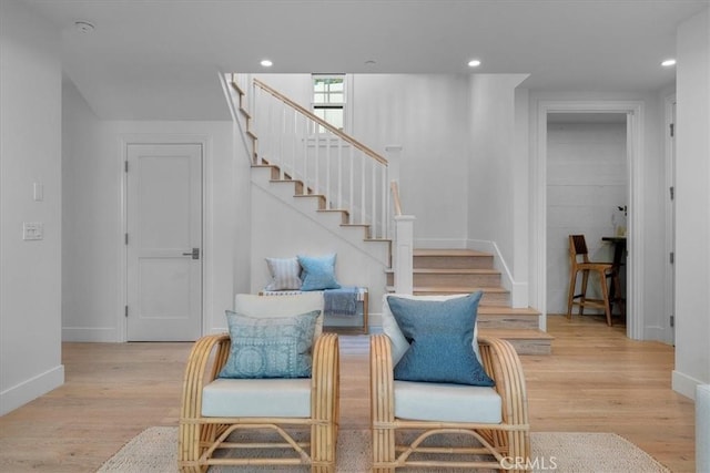 interior space featuring stairs, light wood finished floors, baseboards, and recessed lighting