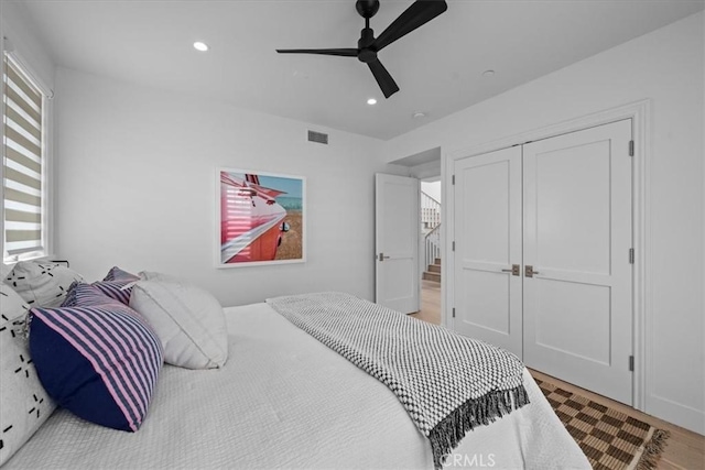 bedroom with visible vents, a ceiling fan, wood finished floors, a closet, and recessed lighting