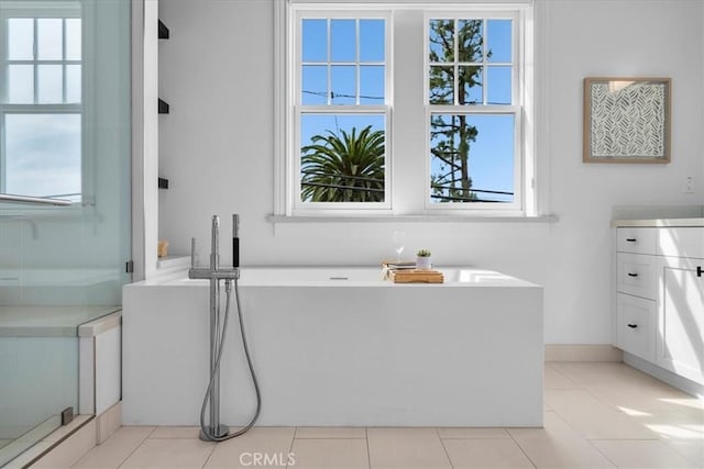 full bathroom with a freestanding tub, tile patterned flooring, vanity, and a shower stall