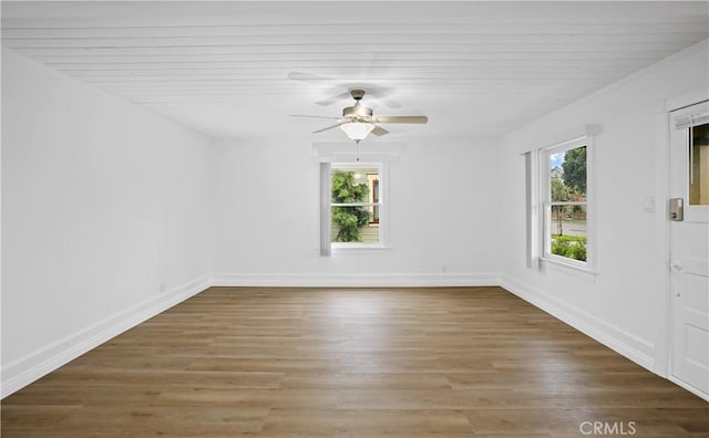 spare room with a ceiling fan, baseboards, and wood finished floors