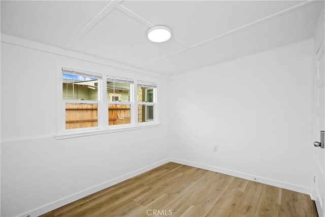 empty room with light wood-type flooring and baseboards