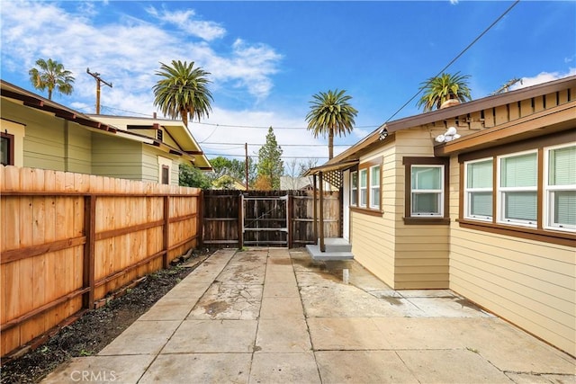 exterior space with a gate, a patio area, and fence