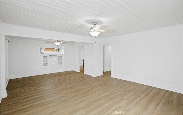 spare room featuring light wood-type flooring, baseboards, and a ceiling fan