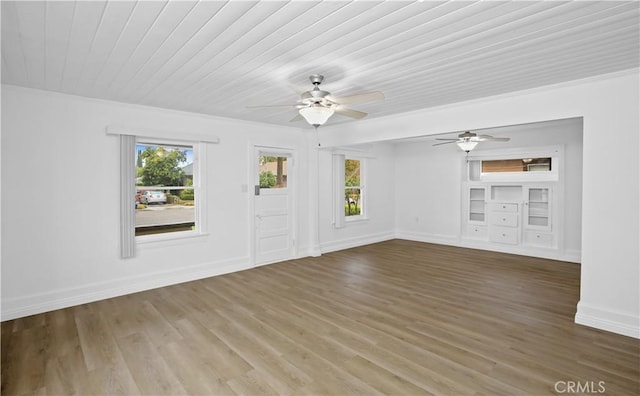 interior space with wood ceiling, ceiling fan, baseboards, and wood finished floors