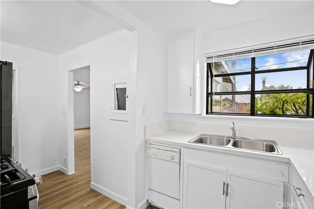 kitchen featuring light wood finished floors, white cabinetry, a sink, gas range, and dishwasher