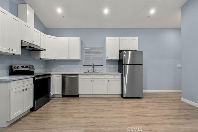 kitchen with light countertops, appliances with stainless steel finishes, white cabinets, a sink, and under cabinet range hood