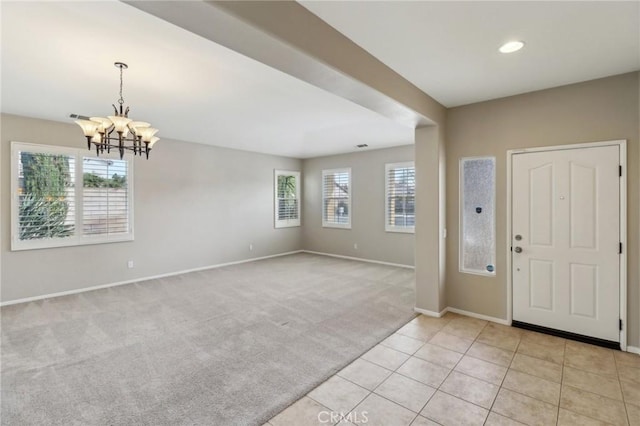 entrance foyer featuring light tile patterned floors, baseboards, light colored carpet, a chandelier, and recessed lighting