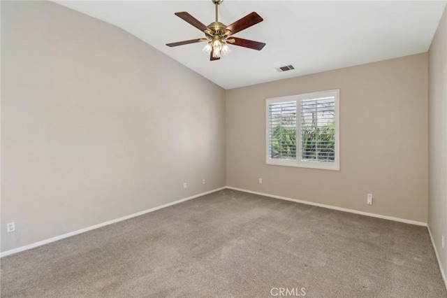 carpeted empty room with lofted ceiling, visible vents, ceiling fan, and baseboards