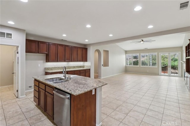 kitchen with stainless steel dishwasher, visible vents, a sink, and light tile patterned flooring