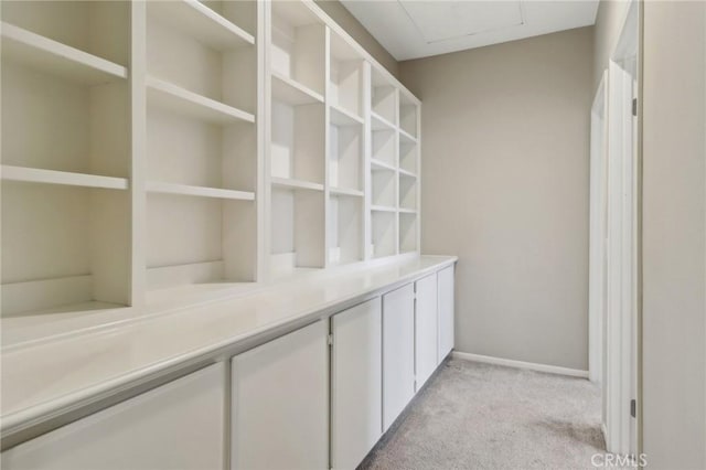 interior space with carpet and baseboards