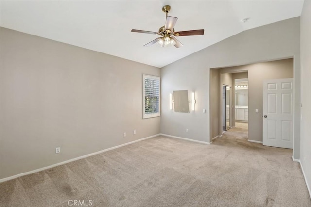 unfurnished room featuring a ceiling fan, lofted ceiling, light carpet, and baseboards