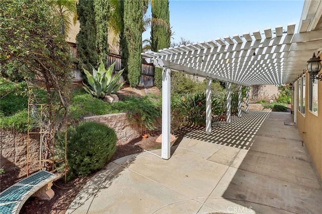 view of patio featuring fence and a pergola